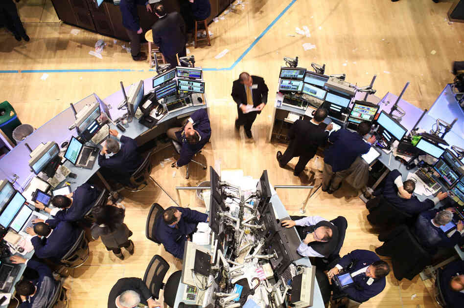 Traders work on the floor of the New York Stock Exchange in December. In the past year, banks in New York and around the country have announced tens of thousands of job cuts, as there isn't the same need for some financial services as before. Traders work on the floor of the New York Stock Exchange in December. In the past year, banks in New York and around the country have announced tens of thousands of job cuts, as there isn't the same need for some financial services as before.