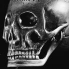 An engraved metal skull which once belonged to Mary, Queen of Scots, bearing inscriptions relating to death. The skull unhinges to expose a watch. An engraved metal skull which once belonged to Mary, Queen of Scots, bearing inscriptions relating to death. The skull unhinges to expose a watch.