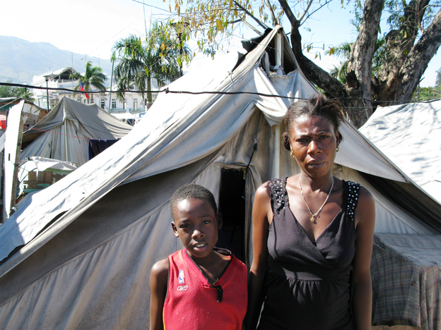 Gerline Rousole, 22, stands next to her son, Savoiu, 7, in Place Pigeon, a displaced-person camp outside the National Palace in Port-Au-Price. Both of Rousole's parents died in the Jan. 12, 2010, earthquake. "If my parents were still alive, I wouldn't be here," she says. 