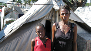 Gerline Rousole, 22, stands next to her son, Savoiu, 7, in Place Pigeon, a displaced-person camp outside the National Palace in Port-Au-Price. Both of Rousole's parents died in the Jan. 12, 2010, earthquake. "If my parents were still alive, I wouldn't be here," she says.