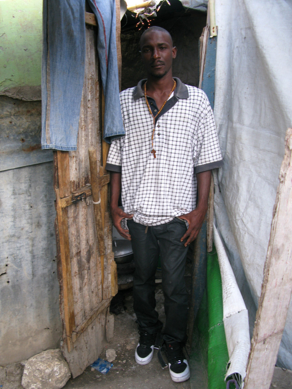  Charles Giiagliard, his wife and his five children live in this one-room shack in downtown Port-au-Prince. The Giiagliards are among half a million people who still live in the squalid tent camps seen all over Haiti's capital.