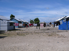 Seventy-three temporary wooden shelters were built last month by the American Red Cross together with other nongovernmental organizations in the Cite Soleil neighborhood of Port-au-Prince. Some residents of the new settlement, Village Carvil, have already added living space with tarps. Seventy-three temporary wooden shelters were built last month by the American Red Cross together with other nongovernmental organizations in the Cite Soleil neighborhood of Port-au-Prince. Some residents of the new settlement, Village Carvil, have already added living space with tarps.