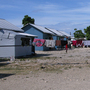  Seventy-three temporary wooden shelters were built last month by the American Red Cross together with other nongovernmental organizations in the Cite Soleil neighborhood of Port-au-Prince. Some residents of the new settlement, Village Carvil, have already added living space with tarps.