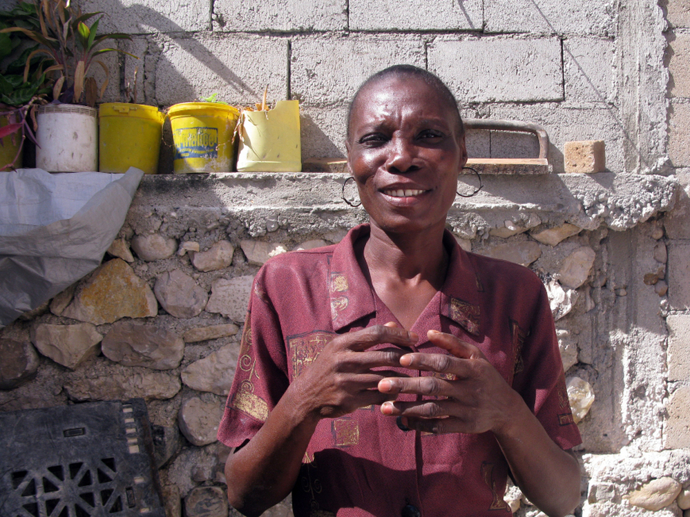 Elicia Andre, who says she used to be much larger — a sign of affluence in Haiti — is now skin and bones.