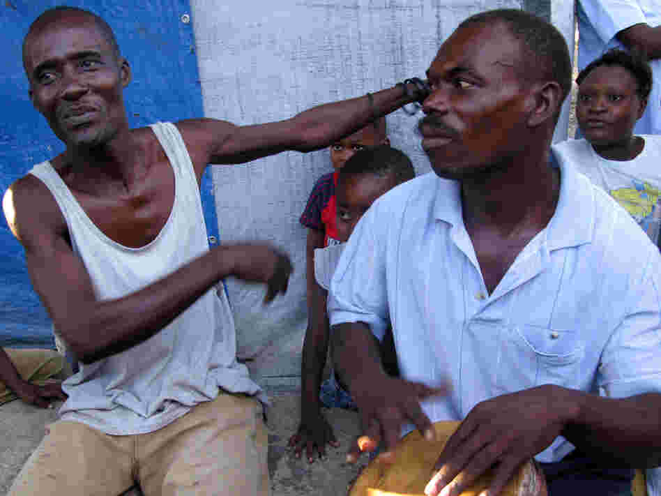 Pierre Jean Nelson (left) has lived at Champs de Mars, a camp for displaced people, since the quake hit. 