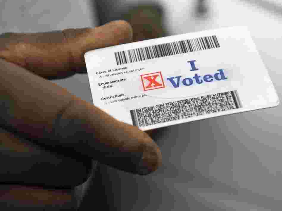 Verdell Winder of Washington holds up his driver's license showing his "I Voted" sticker after voting on Election Day on Nov. 4, 2008.