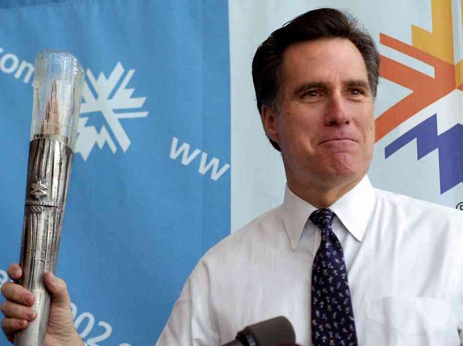 Romney, then-president of the SLOC, holds the planned Olympic torch during a news conference in February 2001 in Salt Lake City. 