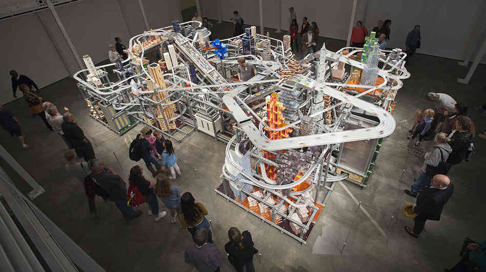 About 1,200 tiny custom-made cars zoom around Metropolis II. If there's an accident, the sculpture comes with nearly 11,000 more toy cars, ready to hit the road. About 1,200 tiny custom-made cars zoom around Metropolis II. If there's an accident, the sculpture comes with nearly 11,000 more toy cars, ready to hit the road.
