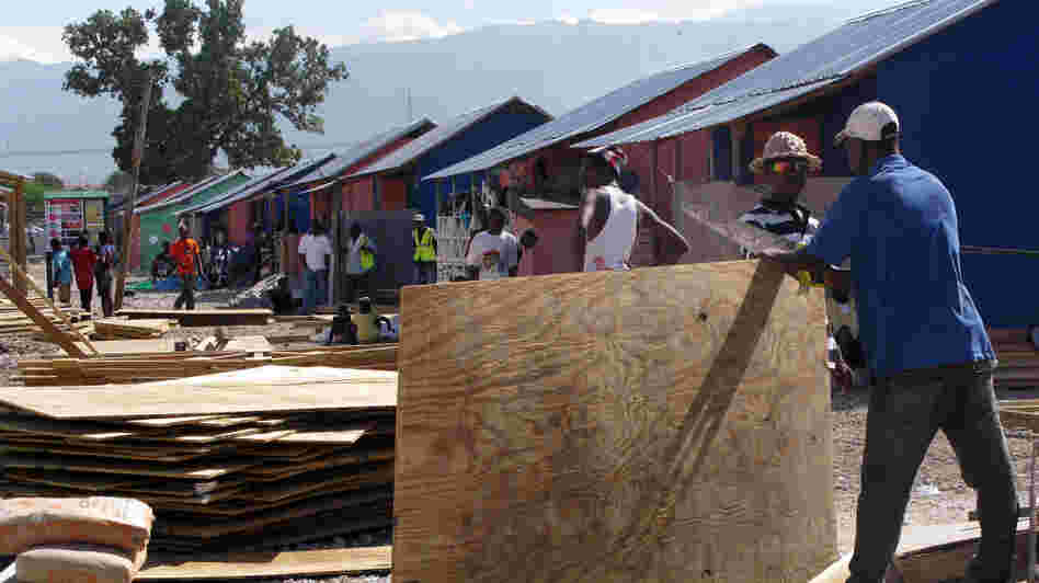 Last year, the Annex de Martissant area of Port-au-Prince was a camp for displaced people. The area was filled with tents. Today, locals are building sturdier shelters with funding from the American Red Cross. Last year, the Annex de Martissant area of Port-au-Prince was a camp for displaced people. The area was filled with tents. Today, locals are building sturdier shelters with funding from the American Red Cross.