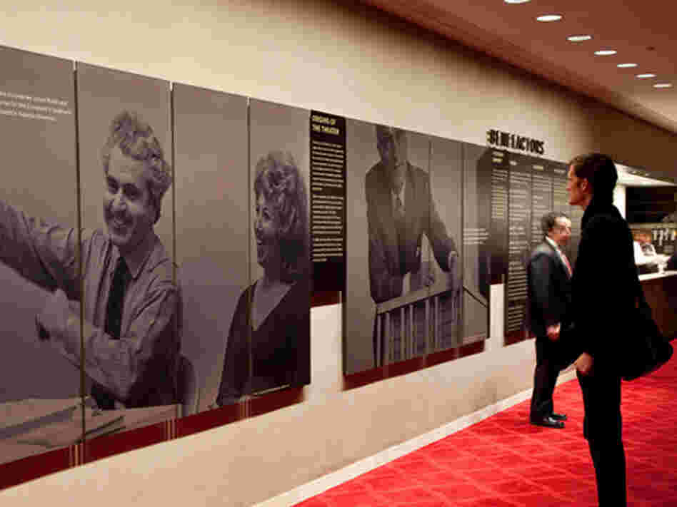 In better days, a New York City Opera attendee takes in a display about the beleagured company's rich history.