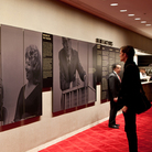 In better days, a New York City Opera attendee takes in a display about the beleagured company's rich history.
