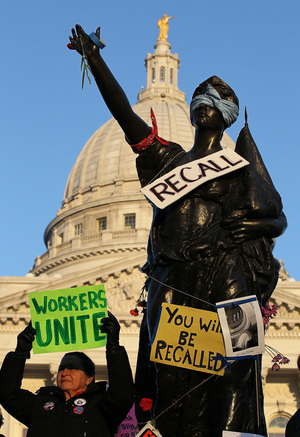 A sign to recall Wisconsin Gov. Scott Walker hangs on a statue in front of the Wisconsin State Capitol in Madison last March. The recall petition drive began in November, and Democrats will turn in signatures Tuesday. A sign to recall Wisconsin Gov. Scott Walker hangs on a statue in front of the Wisconsin State Capitol in Madison last March. The recall petition drive began in November, and Democrats will turn in signatures Tuesday.
