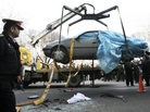 People gather around a car as it is removed by a mobile crane in Tehran, Iran. The car was being driven by Iranian nuclear scientist Mostafa Ahmadi Roshan when it was targeted by a bomb Wednesday. Roshan was killed in the blast. People gather around a car as it is removed by a mobile crane in Tehran, Iran. The car was being driven by Iranian nuclear scientist Mostafa Ahmadi Roshan when it was targeted by a bomb Wednesday. Roshan was killed in the blast.
