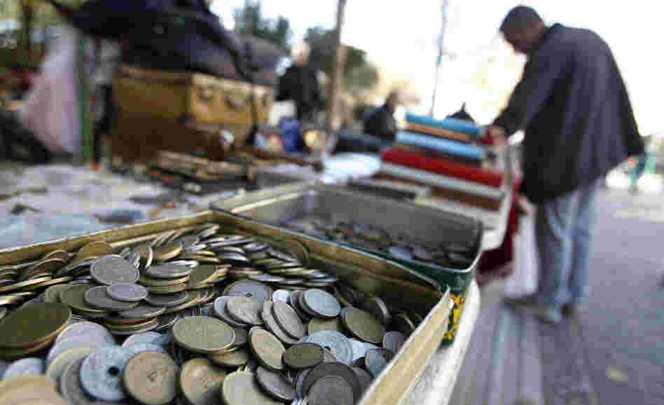 Old drachma coins are displayed for sale at an outdoor market in Athens. If the international community concludes that Greece can't be saved as a member of the Eurozone it will have to revert to its old currency.