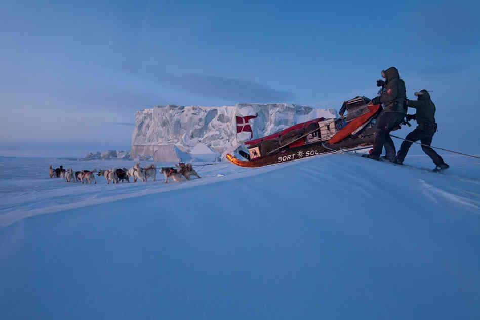 As the sun sets, the team drives toward an iceberg in Hyde Fjord near the top of Greenland. After two years with the dogs, "you know them better than high school friends," Rasmus says.