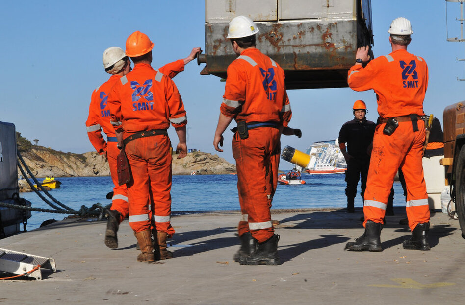 Workers prepare to recover fuel from the damaged ship on Wednesday. The ship was carrying about a half-million gallons of fuel. So far, there is no sign that it has leaked.