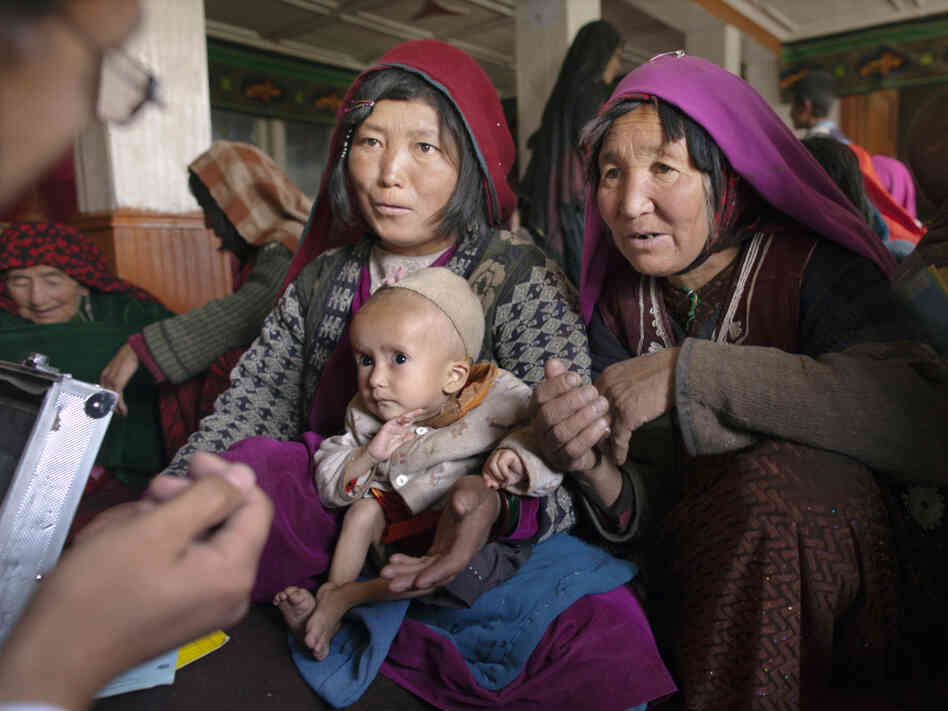 Dr. Mohammed Rashidi talks to a mother about her severely malnourished baby at a makeshift mobile health clinic in a remote village in Afghanistan's Bamiyan province last year. Dr. Mohammed Rashidi talks to a mother about her severely malnourished baby at a makeshift mobile health clinic in a remote village in Afghanistan's Bamiyan province last year.