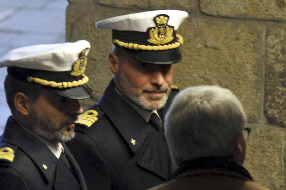 Coast Guard Capt. Gregorio De Falco (center) arrives Tuesday at the Grosseto court in Italy for a hearing. In a dramatic phone conversation, De Falco was heard ordering Francesco Schettino, the captain of the stricken cruise liner, to get back onboard and oversee the evacuation. 