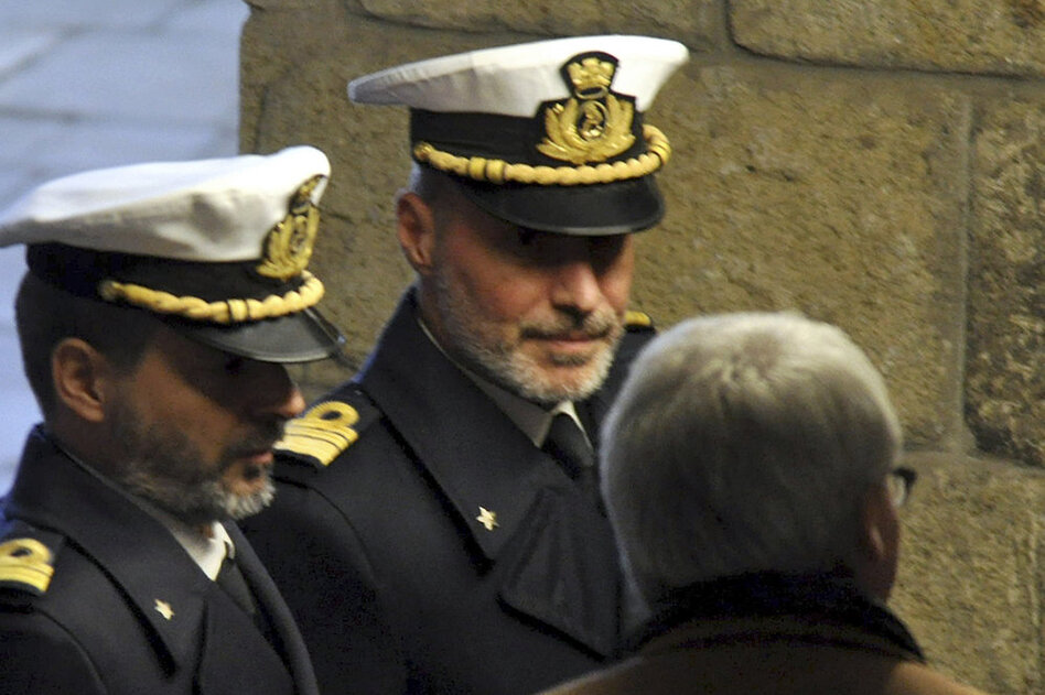 Coast Guard Capt. Gregorio De Falco (center) arrives Tuesday at the Grosseto court in Italy for a hearing. In a dramatic phone conversation, De Falco was heard ordering Francesco Schettino, the captain of the stricken cruise liner, to get back onboard and oversee the evacuation.