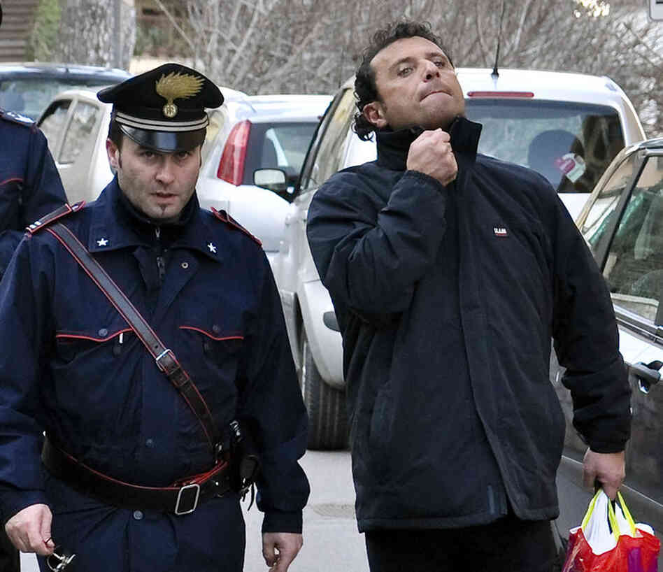 Capt. Francesco Schettino (right) is taken into custody by police in Porto Santo Stefano, Italy, on Jan. 14. Schettino was released Tuesday and is under house arrest in southern Italy. He is being investigated on possible manslaughter charges and abandoning his ship. 