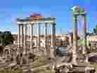 Ancient columns of the Temple of Saturn in the Roman Forum in Rome. Historians have noted that the Roman Empire expanded beyond its abilities to defend its borders. Ancient columns of the Temple of Saturn in the Roman Forum in Rome. Historians have noted that the Roman Empire expanded beyond its abilities to defend its borders.