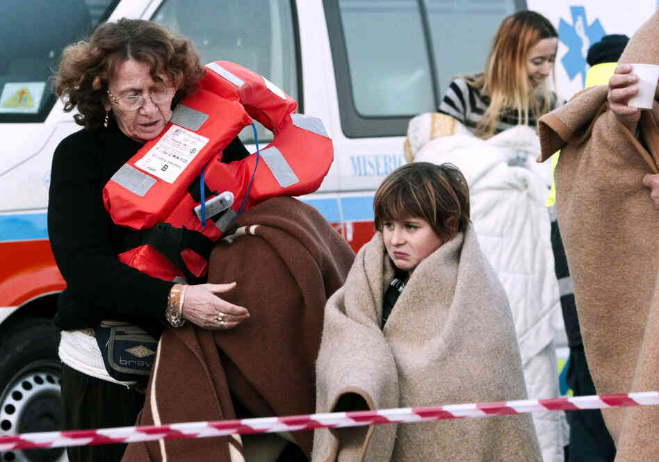 Passengers disembark at a ferry in Porto Santo Stefano, Italy, on Saturday. 
