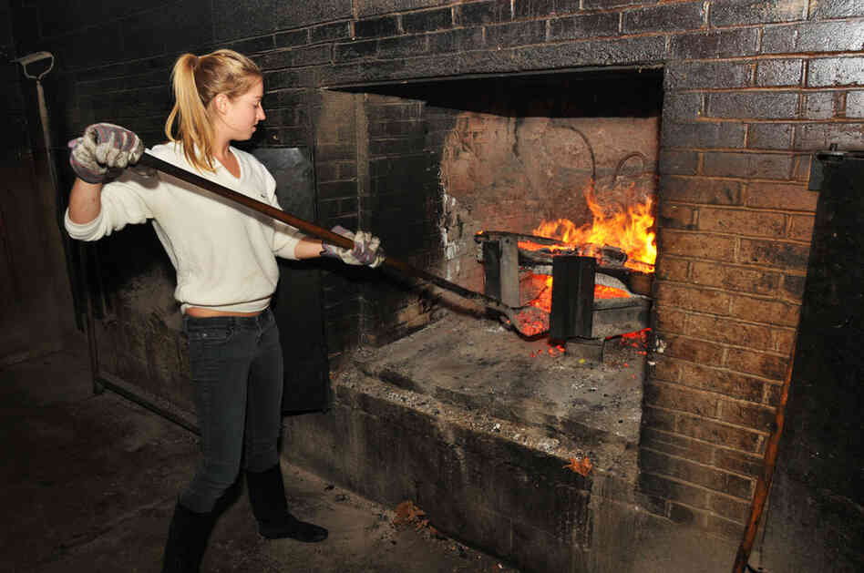 Molly, who left her job as a chef at a Michelin-starred French restaurant in New York City, hoped to learn from the masters of barbecue. Molly feeds hickory embers to the fire at 30-minute intervals at Allen and Son BBQ in Chapel Hill, N.C.