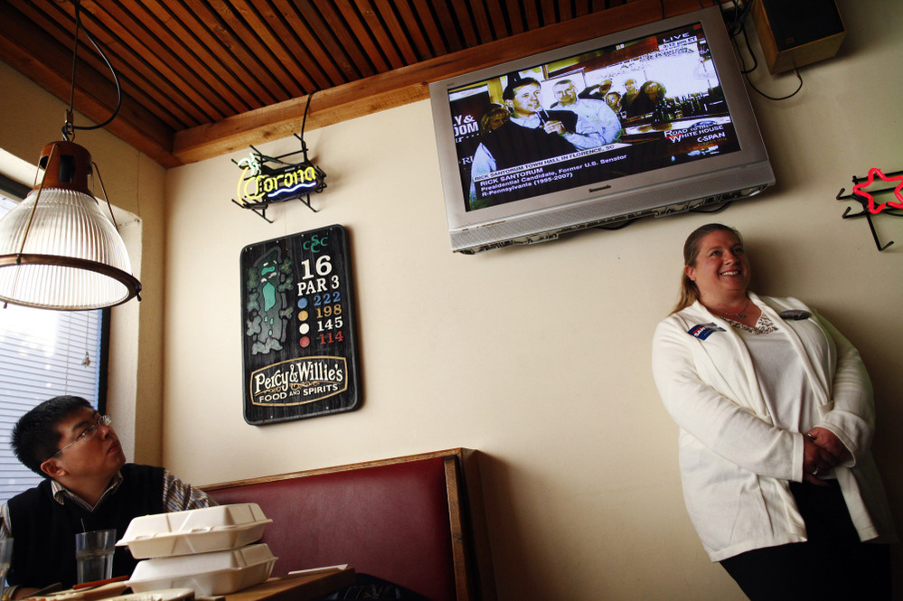 Republican presidential candidate Rick Santorum is seen on a TV screen at a restaurant in Florence, S.C., on Sunday. 