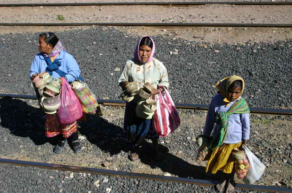In this photo taken on Nov. 9, 2011, Tarahumara women are seen peddling goods to passengers of El Chepe, a government-run train.