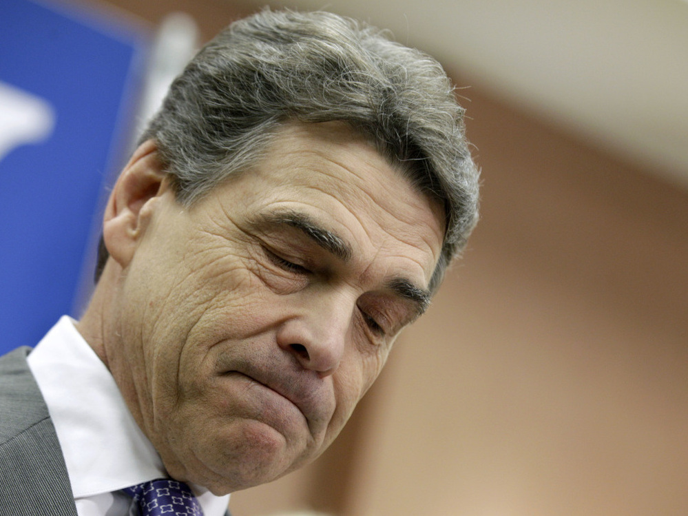 Perry pauses while announcing he is suspending his campaign and endorsing Newt Gingrich, Thursday in North Charleston, S.C. 