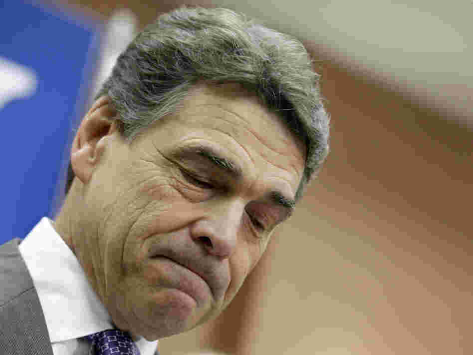 Perry pauses while announcing he is suspending his campaign and endorsing Newt Gingrich, Thursday in North Charleston, S.C. 