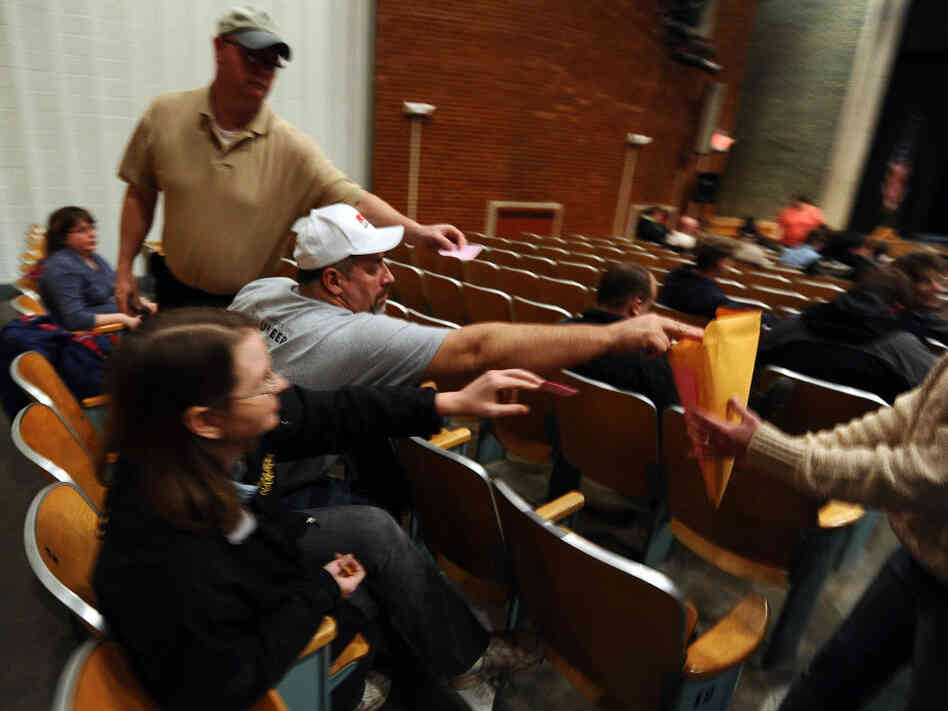 Iowa caucusgoers deposit their ballots on Jan. 3 at a school in Des Moines. On Thursday, the state GOP said it could not account for all votes from the caucuses.