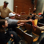 Iowa caucusgoers deposit their ballots on Jan. 3 at a school in Des Moines. On Thursday, the state GOP said it could not account for all votes from the caucuses.