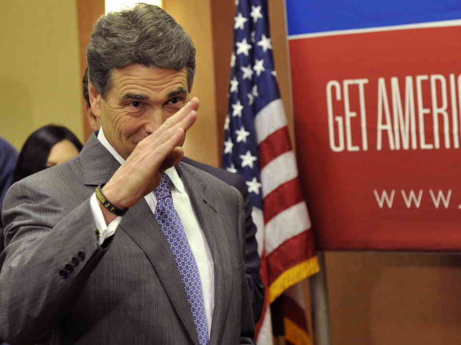 Texas Gov. Rick Perry salutes after announcing that he is suspending his campaign as a Republican presidential candidate.