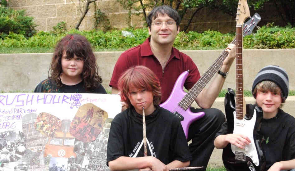 Gary Marcus plays bass in the band Rush Hour, which is made up of 11-year-olds (left to right: Sarah, Riley and Ryan) that he met at band camp. 
