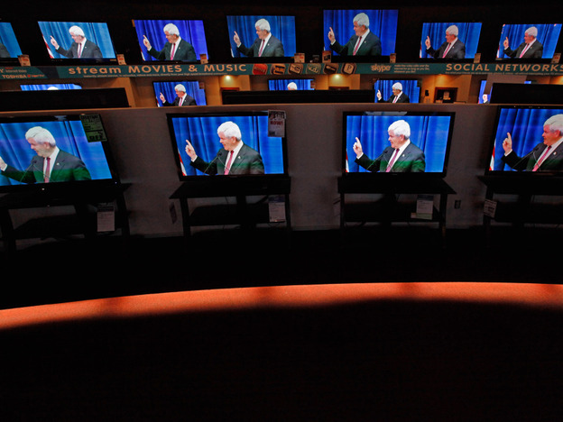 Dozens of televisions display a political advertisement with the image of GOP presidential hopeful Newt Gingrich at a store in Urbandale, Iowa, on Dec. 27. Republican candidates and their superPACs have spent millions on television and radio ads.