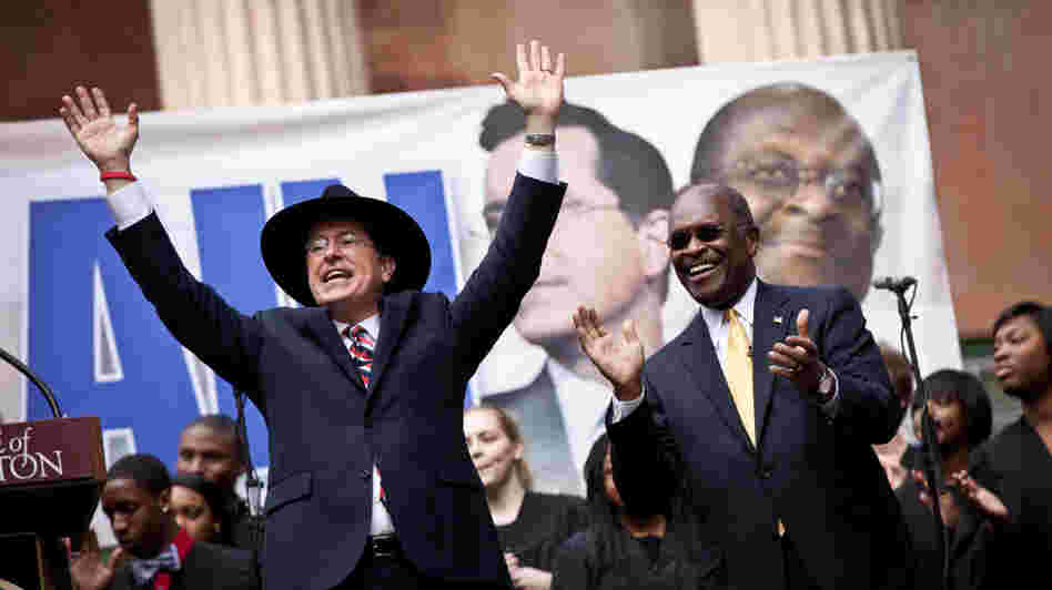 Comedian Stephen Colbert, left, holds a rally with former GOP presidential candidate Herman Cain at the College of Charleston in South Carolina. 