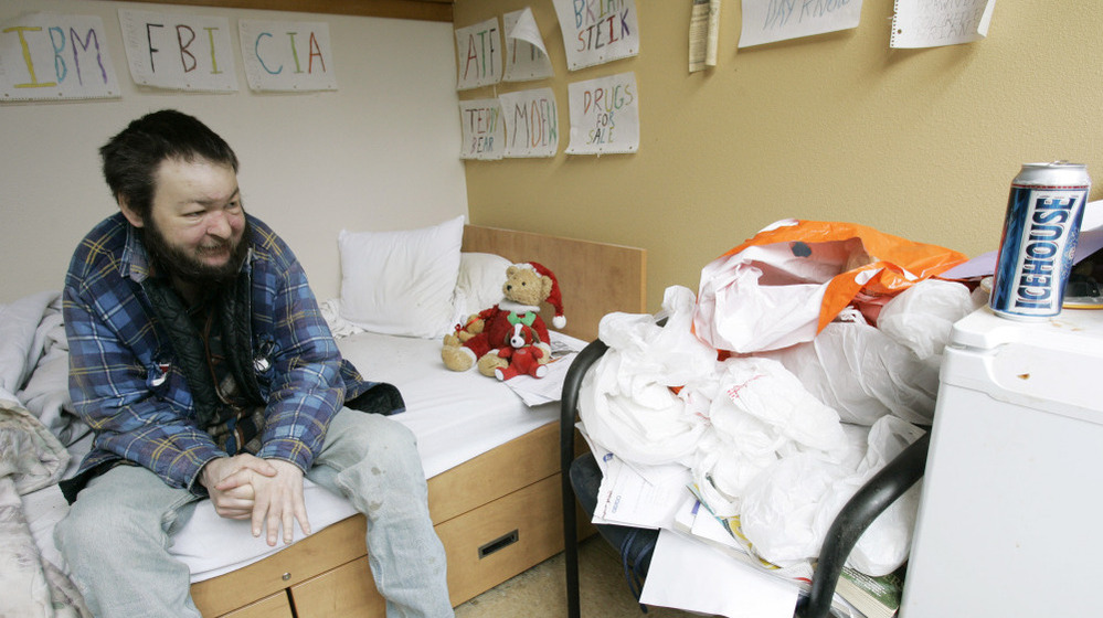 Brian Steik sits in his cubicle at a apartment building for homeless alcoholics in Seattle. 