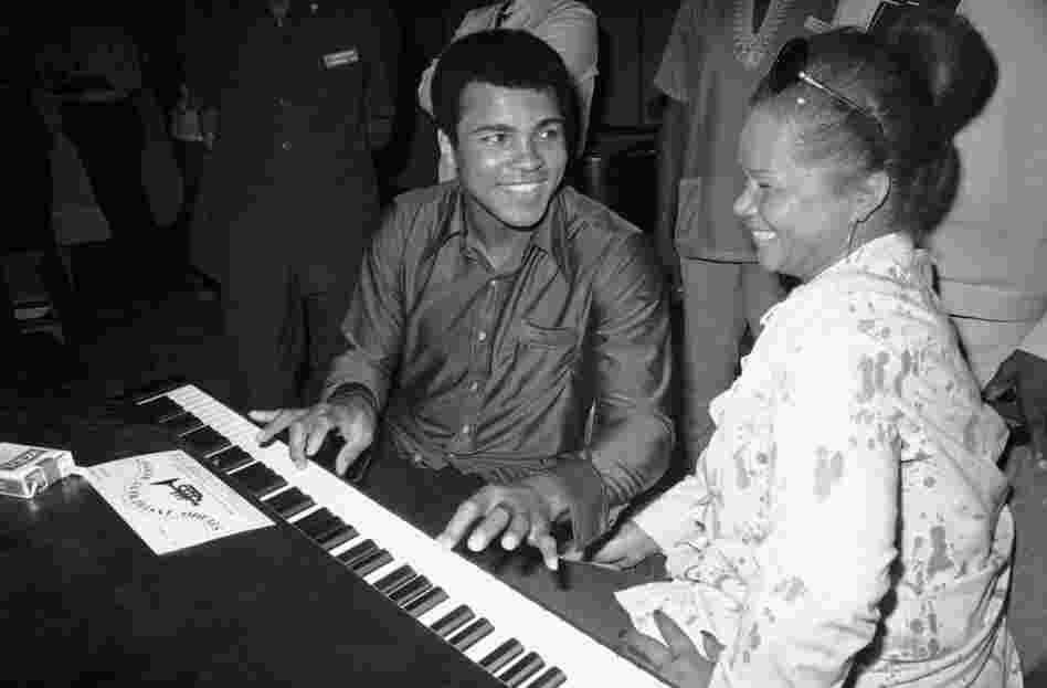 Muhammad Ali plays a few notes on the piano with Etta James while visiting black American artists that performed in the Zaire 74 music festival in Kinshasa, Zaire on Sept. 22, 1974.
