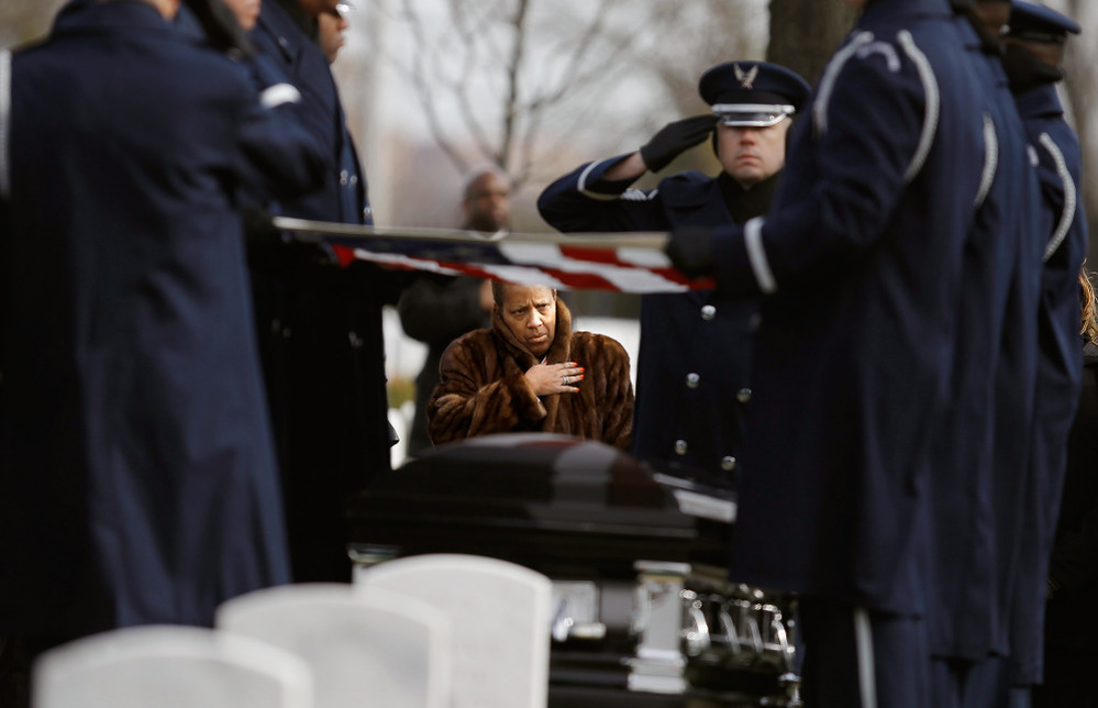 Family, friends and admirers salute the casket of Luke Weathers, Jr., one of the original Tuskegee airmen, at his burial ceremony at Arlington National Cemetery.
