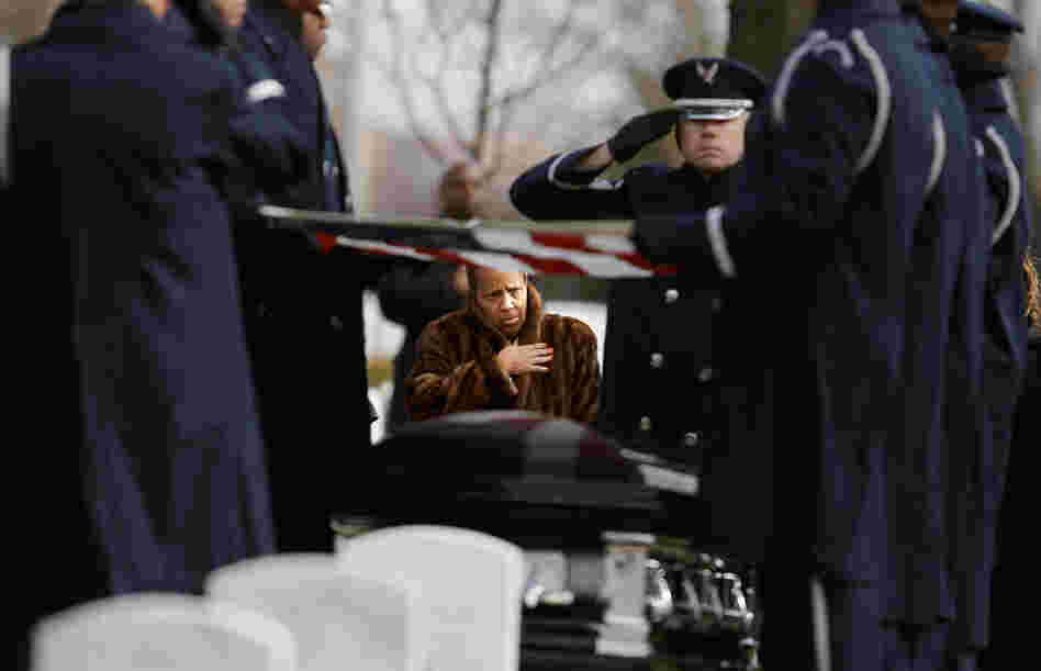 Family, friends and admirers salute the casket of Luke Weathers, Jr., one of the original Tuskegee airmen, at his burial ceremony at Arlington National Cemetery.