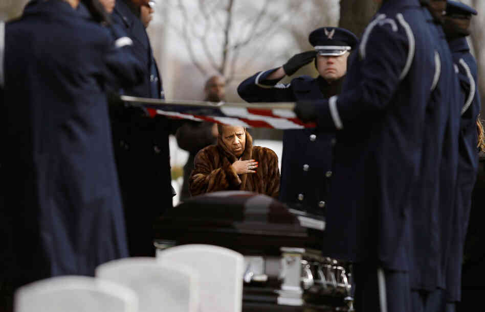 Family, friends and admirers salute the casket of Luke Weathers, Jr., one of the original Tuskegee airmen, at his burial ceremony at Arlington National Cemetery.