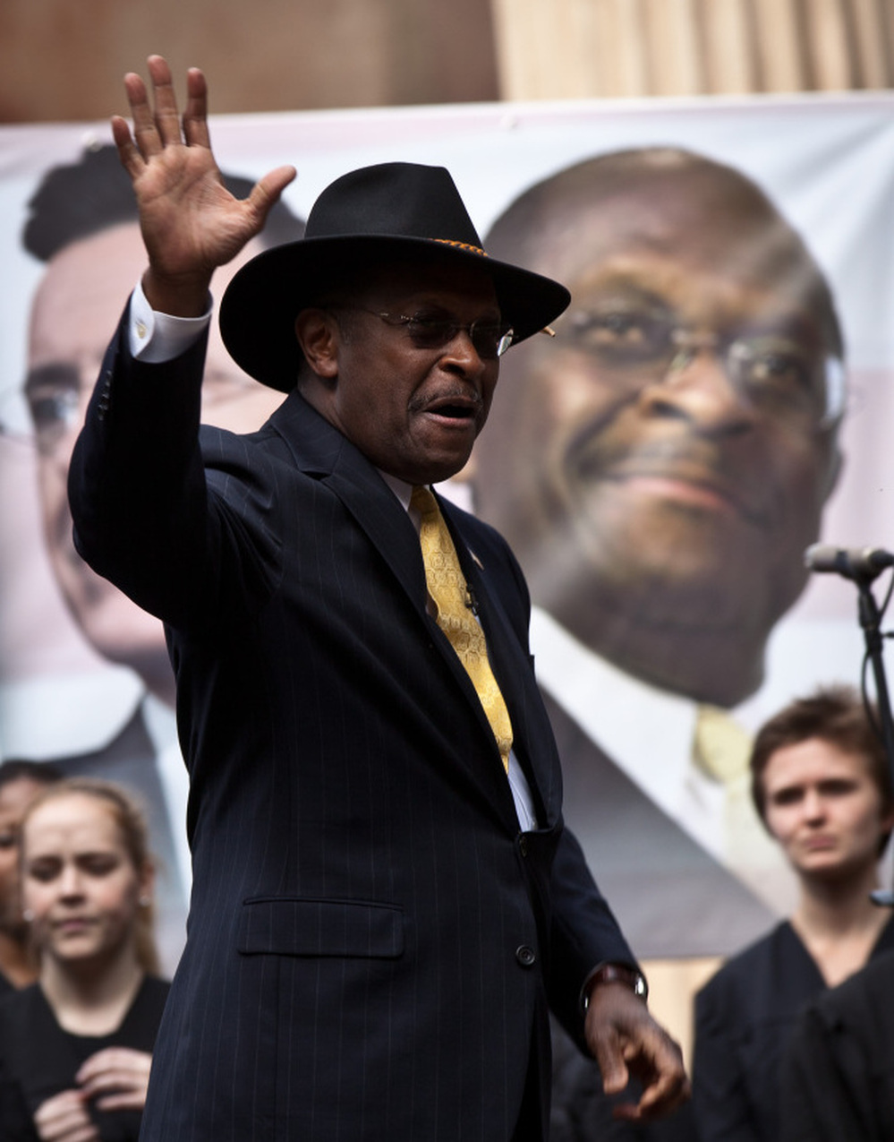 Former GOP presidential candidate Herman Cain waves at a rally the College of Charleston on January 20, 2012. Comedian Stephen Colbert held the event with Cain, titled "Rock Me Like a Herman Cain South Cain-olina Primary Rally", as part of his pseudo-run for president of "The United States of South Carolina." 
