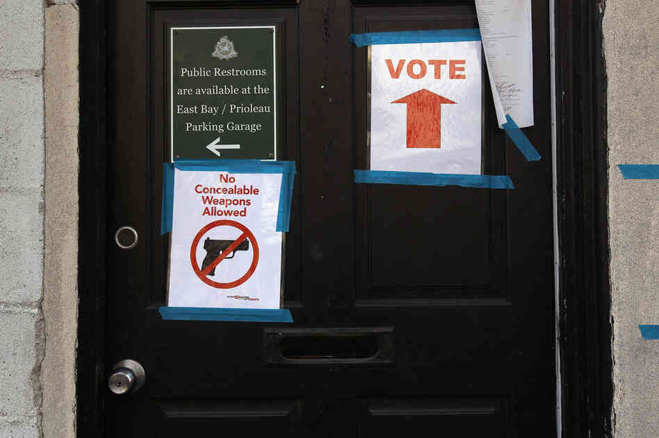 Signs adorn the doorway of a polling station in Charleston, S.C. 