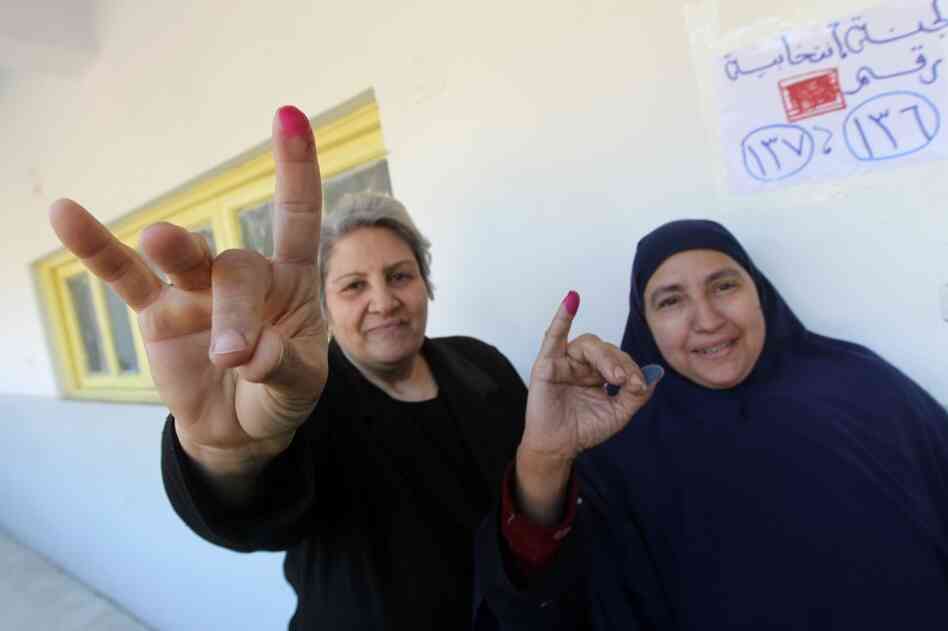 Egyptian women show their ink-stained fingers after voting at a polling station earlier this month. According to the election results, less than 2 percent of parliamentarians will be female.