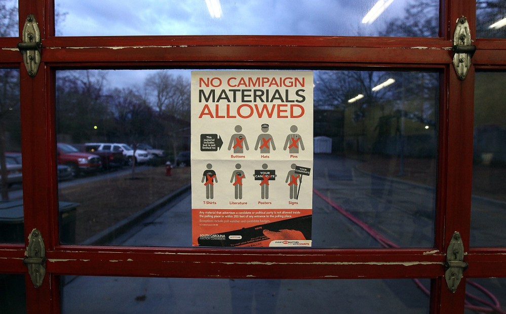 A voting regulations sign is displayed at the Shandon Fire Station in Columbia, S.C., on Saturday. 