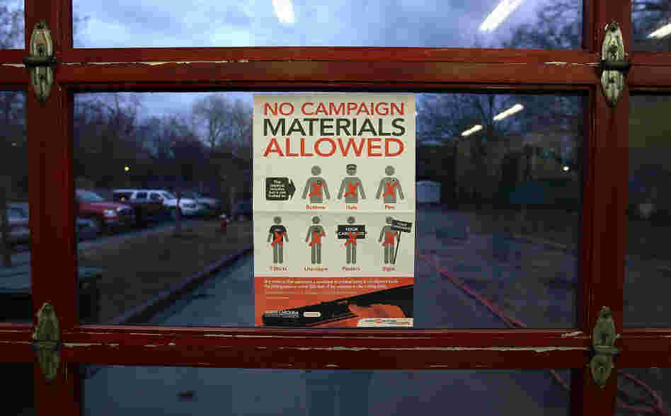 A voting regulations sign is displayed at the Shandon Fire Station in Columbia, S.C., on Saturday. 
