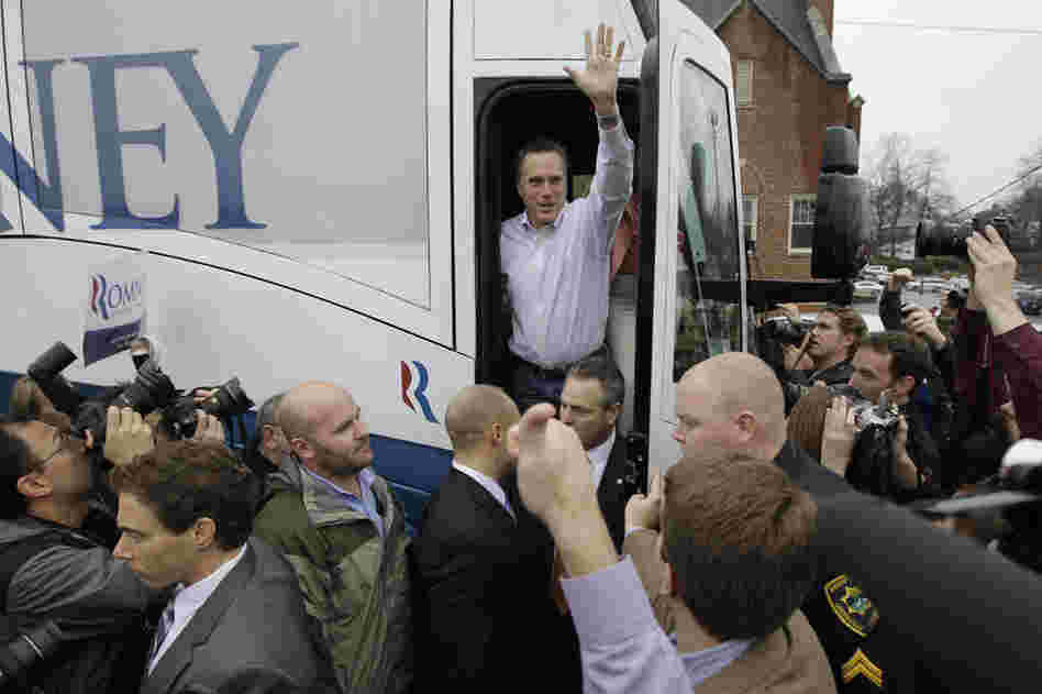 Romney waves from his campaign bus after making a stop at Tommy's Country Ham House in Greenville. 