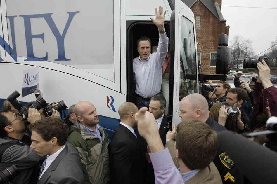 Romney waves from his campaign bus after making a stop at Tommy's Country Ham House in Greenville. 