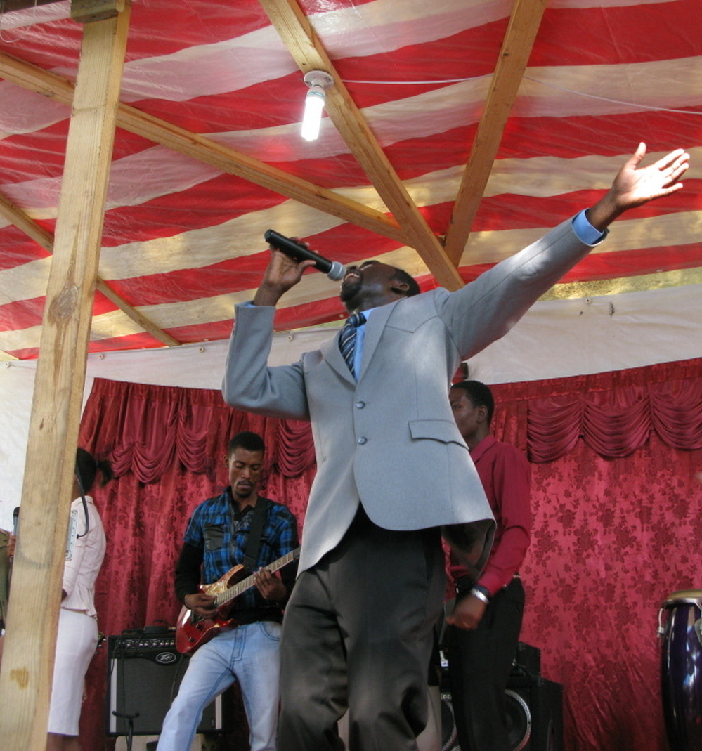 Pastor Junior Antoine on stage at Shalom Tabernacle of Glory evangelical church, in front of a congregation that grew rapidly after the earthquake two years ago.